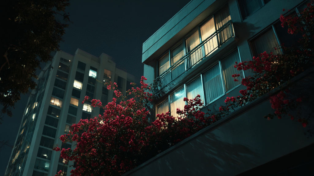 Shadowy figure in a car observing a brightly lit, modern condo at night, conveying suspense for the short story 'A Fine Lesson'.